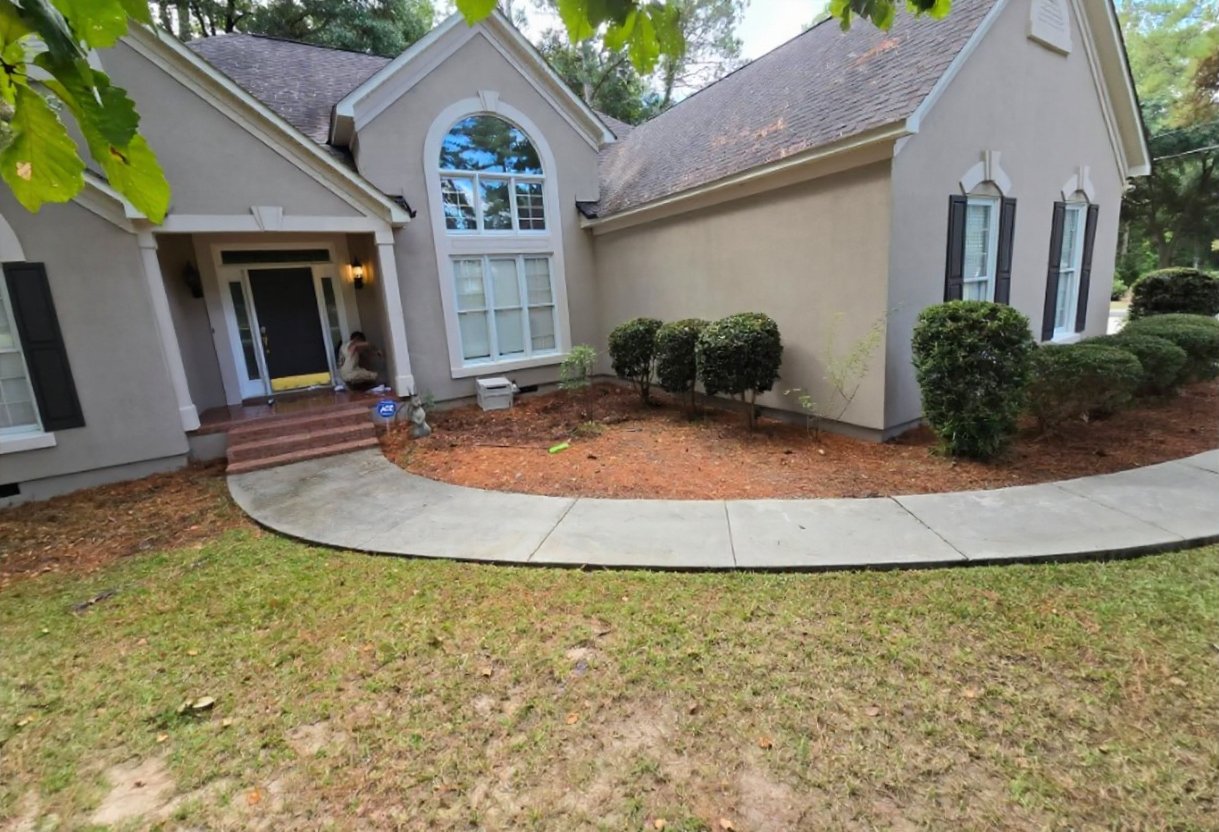 A house front and curved walkway after a wash